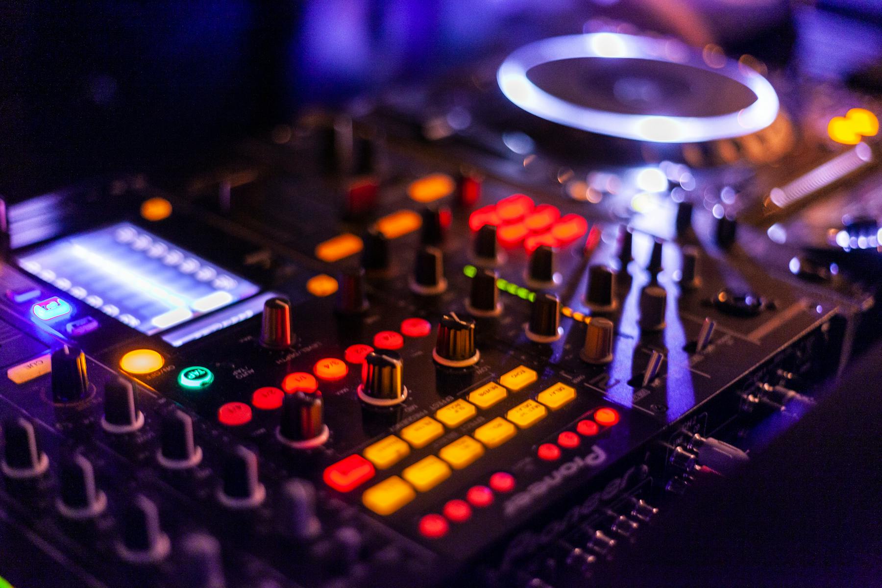 DJ booth with mixer and venue lighting